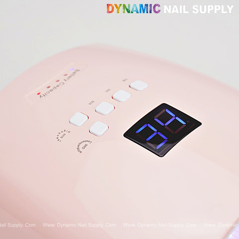 Close-up of the Stawberry Pink Cordless LED/UV Gel Nail Dryer 48W with digital timer and white control buttons.