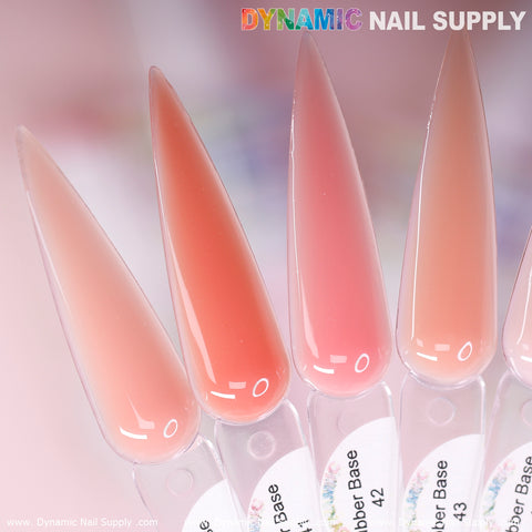 Close-up of five elongated nail polish swatches in varying shades of pink, showcasing the luxe (BIAB) Rubber Base Gel collection from Dynamic Nail Supply. Each is numbered 41 to 45. Set against a softly blurred background, the image features the Dynamic Nail Supply logo at the top right corner.