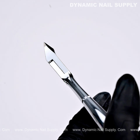 A gloved hand holds the D18 Sharp Cuticle Cutter with a full jaw design against a clean white background.