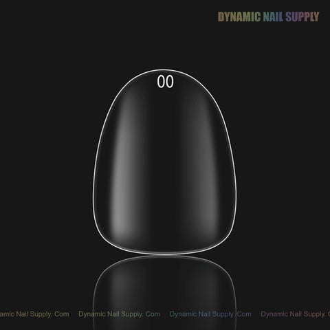 A single Natural Round XS Full Cover Soft-Gel Nail Tip (Pink Box), labeled 00, centered on a black background.
