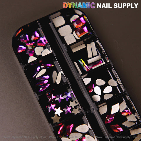 A black tray holds Fuchsia AB 8 mixed rhinestones in raindrop, square, heart, and moon shapes for nail art.