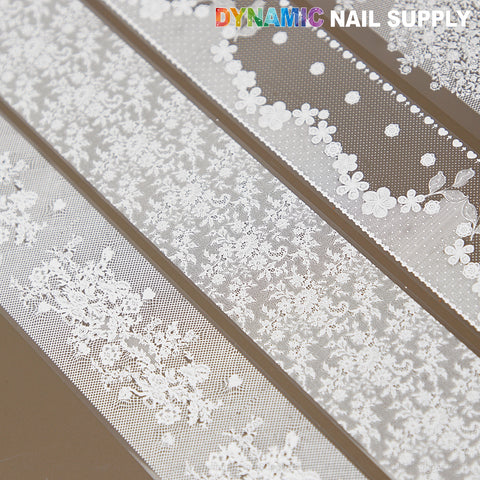 White Mixed Design Nail Foil 4: four white floral lace nail art foils on transparent backing, top view.
