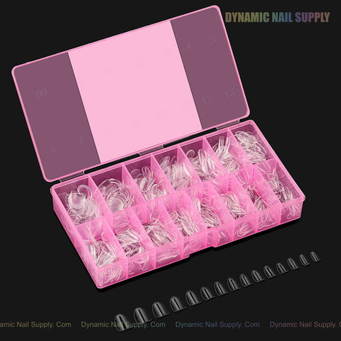 A pink Natural Round XS Full Cover Soft-Gel Nail Tips box holds tips; black Gel-X tips are displayed below on black.