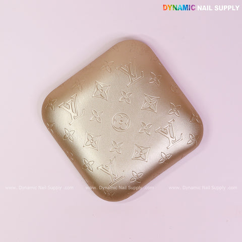 Metallic Gold LV Engrave Elbow Rest Pillow: Soft PU leather, supportive for nail techs, pictured on pink background.
