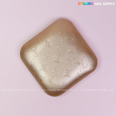 Metallic Gold LV Engrave Elbow Rest Pillow for Nail Tech next to armrest, on a light pink background.