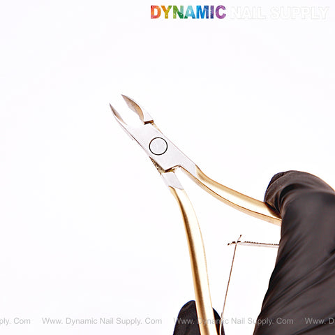 A gloved hand holds NT1223 - G09 4mm Professional Stainless Steel Cuticle Nippers against a white background.