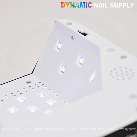 Close-up of Black Small Rhinestone Heart Shape 72W UV/LED Cordless Nail Lamp with display and DYNAMIC NAIL SUPPLY logo.