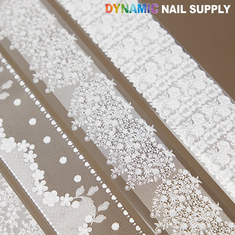White Mixed Design Nail Foil 4: White floral & dot lace art stickers on brown, DYNAMIC NAIL SUPPLY text above.