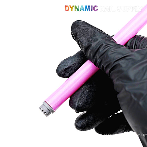 A hand in a black glove holds a pink Silicone Stamper Pen for Nail Art Design; DYNAMIC NAIL SUPPLY is partly visible above.