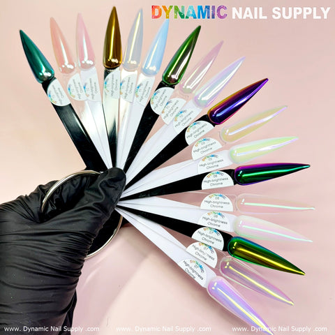 A hand wearing a black glove presents a variety of nail polish swatches, featuring an array of colors from metallic green to light-green/purple mermaid iridescent shades, intensified by the high-brightness fine pigment powder. The scene is gracefully set against a soft pink background, with the Dynamic Nail Supply logo prominently displayed in the corner.