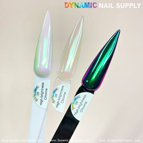 Three elongated, pointed nail samples gleam against a light background. From left to right: a pearlescent white labeled High-Brightness Chrome, Light-green/Purple/Mermaid Iridescent Chrome #08 with an iridescent chrome powder finish, and a reflective multicolored chrome-pigment sample. At the top, Dynamic Nail Supply stands out.