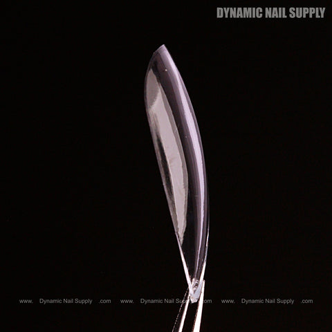 A Natural Stiletto (Medium) Full Cover Soft-Gel Nail Tip is held upright with Dynamic Nail Supply text in the corner.
