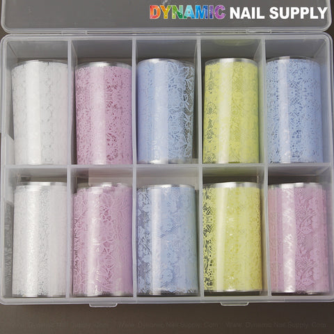 Six mixed-design nail foils—pink, blue, white, yellow—in a clear DYNAMIC NAIL SUPPLY case for nail art.