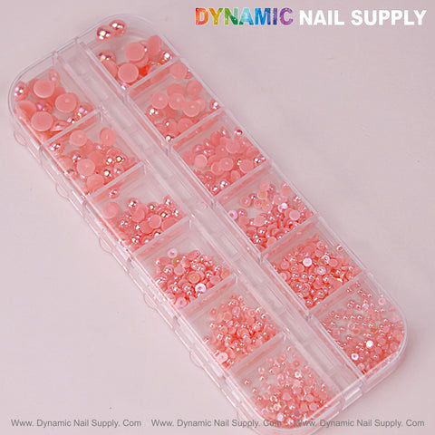 A 12-grid case holds mixed-size pink pearl beads and nail charms for DIY designs, round flatback stones included.