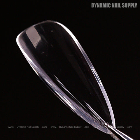 A Natural Stiletto (Medium) Full Cover Soft-Gel Nail Tip (Pink Box) shown close-up, highlighting its smooth, glossy surface.