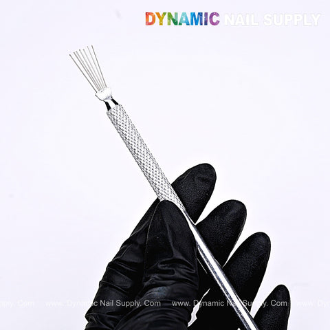 A gloved hand holds the Nail Art Manicure Stainless Steel Brush, a multi-purpose nail clamping tool for designs.