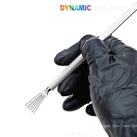 A hand in a black glove holds the Nail Art Manicure Stainless Steel Brush; DYNAMIC NAIL SUPPLY is at the top.