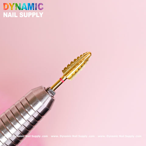 A close-up shot of the 2XC Typhoon Bit showcases its metallic, gold-colored, tapered fluted head against a pink background. The silver handle with a textured grip is ideal for removing acrylic or gel polish. The text "Dynamic Nail Supply" is prominently displayed in the upper left corner.