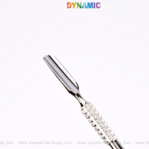 NT1231 – Professional Double-Function Cuticle Pusher (Bevel and Spoon) with textured handle; DYNAMIC NAIL SUPPLY at top.