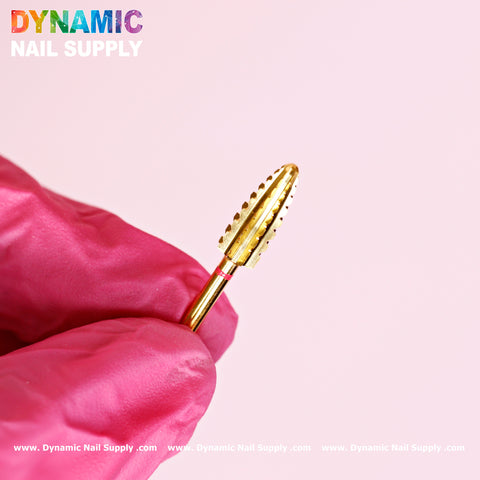 A hand in a pink glove holds the 2XC Typhoon Bit, a double extra coarse drill bit for removing acrylic or gel polish.