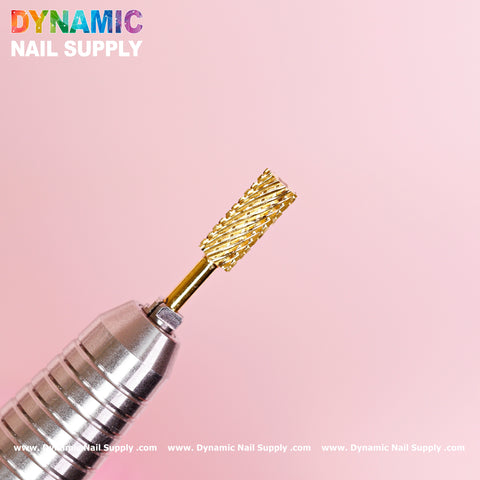 Captured against a light pink backdrop is the 2XC Double Extra Coarse Drill Bit - Small Barrel Carbide. Designed with a spiral pattern, it excels at removing gel or acrylic nails. A metallic, ridged handle rests beneath it. Above in vibrant rainbow colors is the brand name, Dynamic Nail Supply, with its website URL displayed at the bottom.