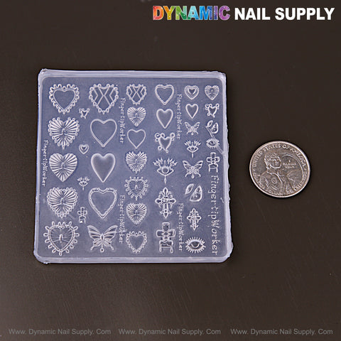 Mixed Style Heart & Butterfly 3D Nail Art Silicone Molds for embossed charms, shown next to a U.S. quarter for scale.