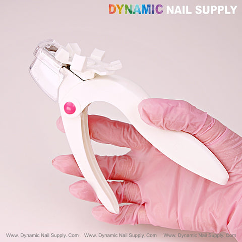 A hand holds the Nail Tip Cutter With Measure Spacers under DYNAMIC NAIL SUPPLY text on a light background.