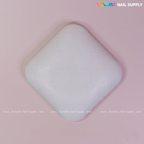 White GC Engrave - Smooth elbow pad pillow: white PU leather, supportive, for nail techs; subtle pattern, logo in corner.