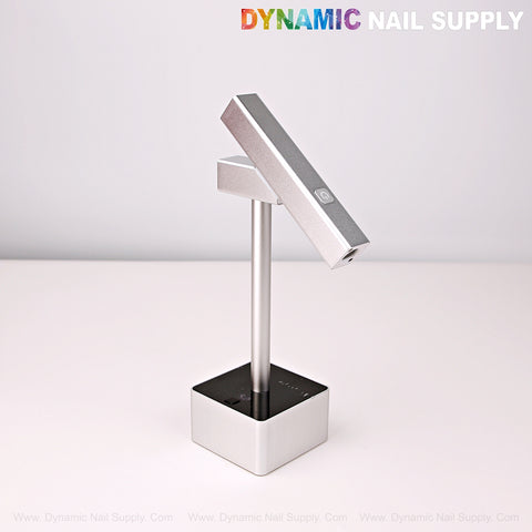 2 in 1 Mini UV/LED Flash Cure Lamp, square base, silver, with DYNAMIC NAIL SUPPLY logo on white surface.