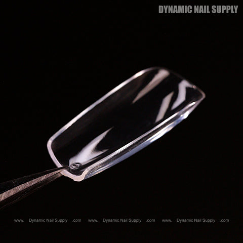 A Sculpted Square (Medium) Soft-Gel Nail Tip held by tweezers, with DYNAMIC NAIL SUPPLY text top right.
