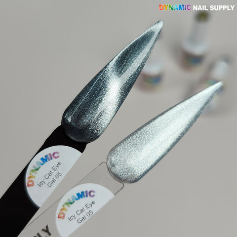Two nail swatches in Icy Cat Eye Gel #05 - Reflective Magnetic Silver, with blurred bottles in the background.