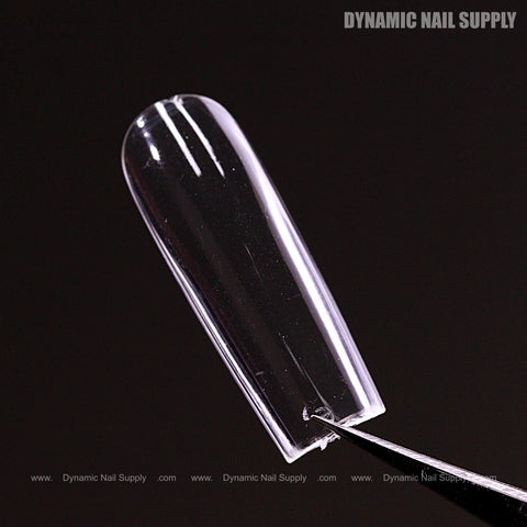 A Sculpted Square (Long) Full Cover Soft-Gel Nail Tip (Pink Box) held by tweezers; “DYNAMIC NAIL SUPPLY” text.