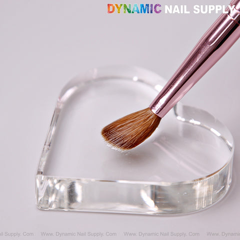 Dynamic Metallic Pink Kolinsky Hair Nail Brush rests on a clear heart dish; DYNAMIC NAIL SUPPLY above.
