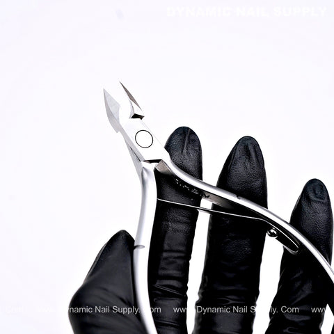 A black-gloved hand holds the D09 Jaw 16 heavy-duty surgical steel cuticle nipper against a white background.