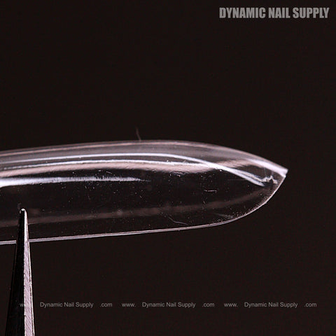 Close-up of Sculpted Square (Long) Full Cover Soft-Gel Nail Tips (Pink Box) held by tweezers, brand text in corner.