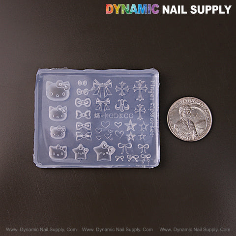 Hell0 K1tty, bows, hearts & cross 3D nail art mold, shown next to a U.S. quarter for scale.