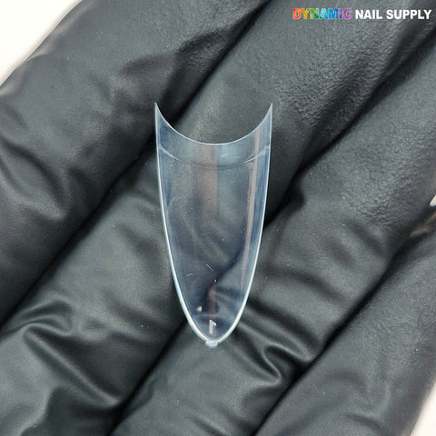 A gloved hand holds a (New 2026) Medium Almond Extension Nail Tip; “DYNAMIC NAIL SUPPLY” logo is shown above.