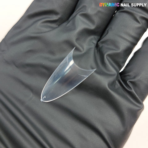 A black-gloved hand holds (New 2026) Medium Almond Extension Nail Tips—500pcs, with DYNAMIC NAIL SUPPLY text above.