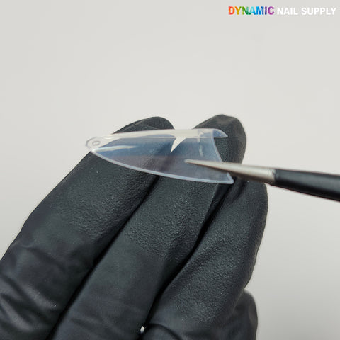 A gloved hand holds a (New 2026) Medium Almond Extension Tip; a brush points at it. DYNAMIC NAIL SUPPLY logo on top right.