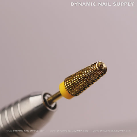 Close-up of Extra Fine (XF) 5-in-1 Volcano Bit for acrylic or gel, gold tungsten carbide on handle, DYNAMIC NAIL SUPPLY above.
