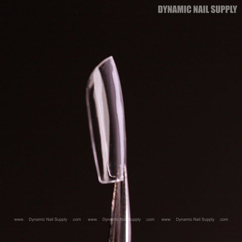 A Natural Square (Short) Full Cover Soft-Gel Nail Tip held by tweezers; DYNAMIC NAIL SUPPLY at top right.
