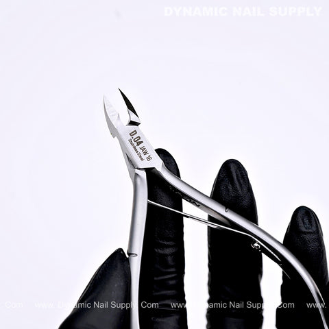 A gloved hand holds the D04 Jaw 16 Pro Cuticle Cutter—ergonomic grip, sharp jaw—against a white background.