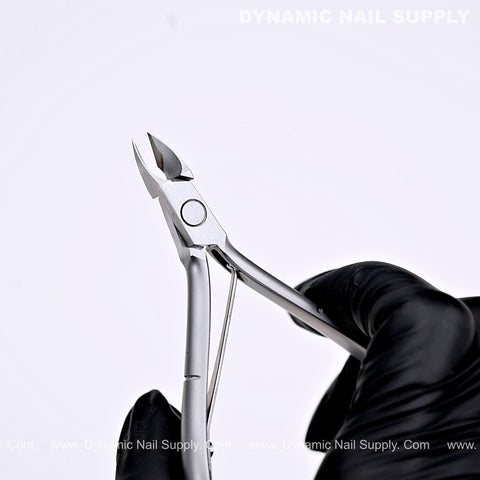 A black-gloved hand holds the D04 Jaw 16 Pro Cuticle Cutter with ergonomic grip against a white background, text top right.