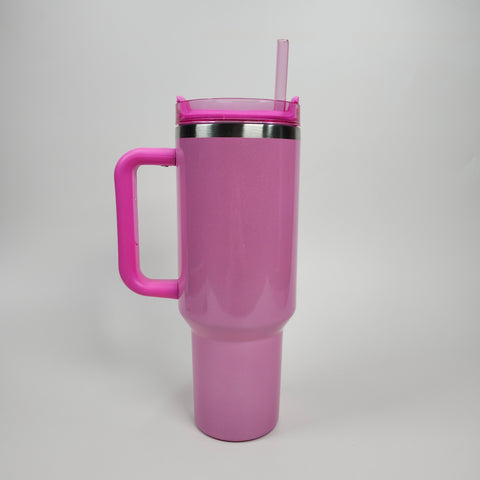 A 40oz light pink stainless steel tumbler with handle, clear lid, straw, and double-wall vacuum insulation.