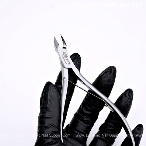 A gloved hand holds the D06 - Jaw 16 Professional Nail Nippers, a full jaw sharp cuticle cutter, against a white background.