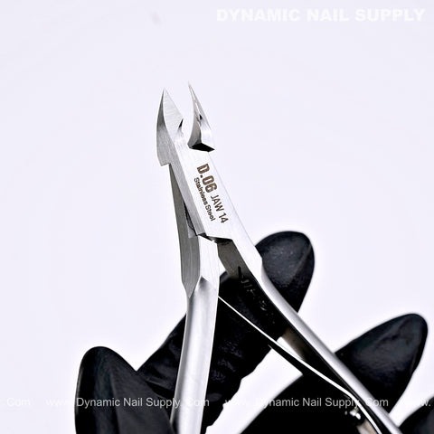 A gloved hand holds the D06 Jaw 14 Precision Cuticle Trimmer Nippers for fingernails and toenails.