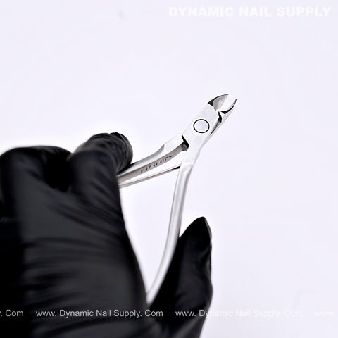 A gloved hand holds the D06 Jaw 14 Precision Cuticle Trimmer Nippers against a plain white background.