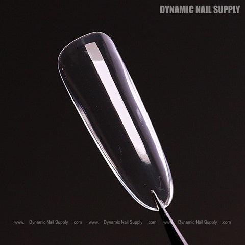 A clear, glossy Natural Round (Long) Full Cover Soft-Gel Nail Tip on black with DYNAMIC NAIL SUPPLY text top right.