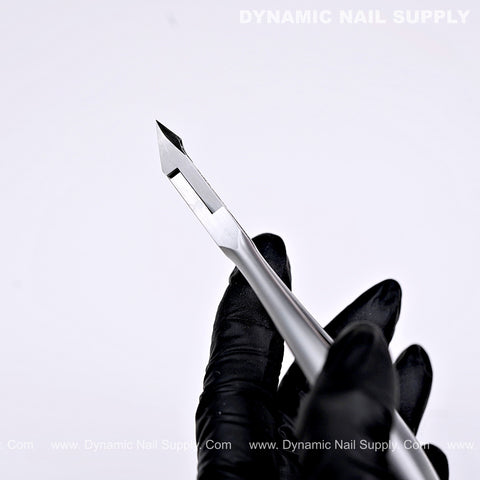 A gloved hand holds the D07 Jaw 14 Cuticle Nippers with a sharp, slanted tip against a white background.