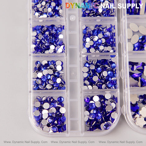 A plastic case holds blue multi-shape nail crystals, labeled “DYNAMIC NAIL SUPPLY” at the top.